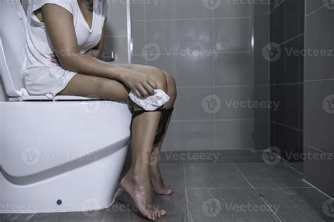 Have Problems With Excretion Conceptan Asian Woman Sits On The Toilet Bowlconstipation And A