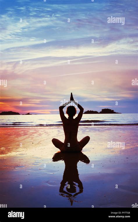 Yoga Silhouette Of Woman Meditating On The Beach Vertical Background