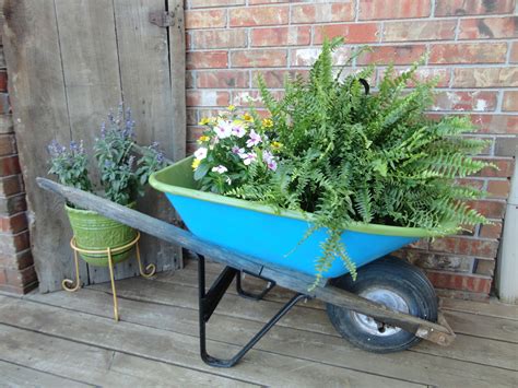Took Old Rusty Wheelbarrow Spray Painted It And Now It Is A Great Flower