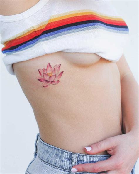 Rib cage tattoos with lettering or names are amazing for women and men. Pink Lotus tattoo on the right rib cage | Pink tattoo ...