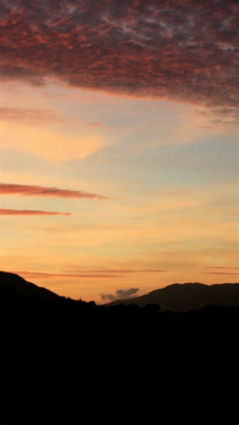 Download Wallpaper 720x1280 Sky Clouds Sunset Hills Dark Samsung
