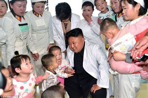 Kim jong un at his father kim jong il's funeral in 2011. Kim Jong-Un poses with children at hospital as he cannot sleep over Pyongyang tower block ...