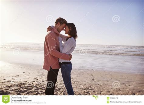 Romantic Couple On Walking Along Winter Beach Together