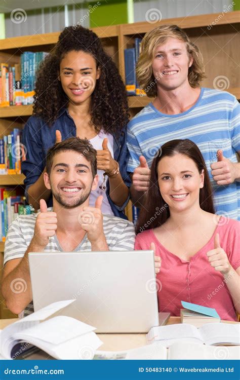 College Students Gesturing Thumbs Up In Library Stock Photo Image Of