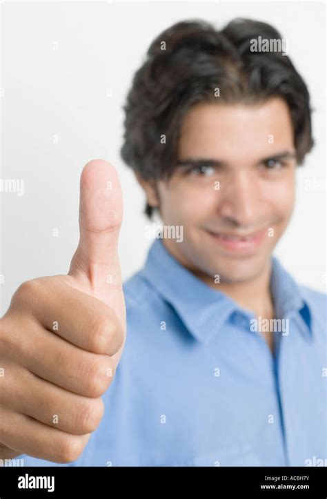 Portrait Of A Young Man Showing Thumbs Up Sign Stock Photo Alamy