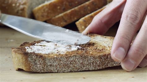 Close Up Hand Spreading Butter On Toasted Bread Youtube