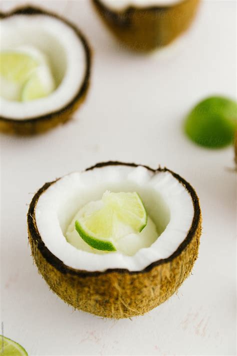 Vertical Of Coconut Shell With Ice Cream Inside And Lime By Stocksy