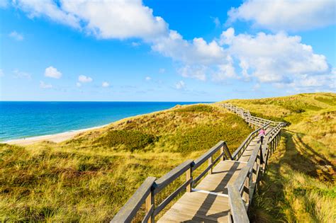 Wooden Walkway Along A Coast Of North Sea And View Of Beautiful Beach