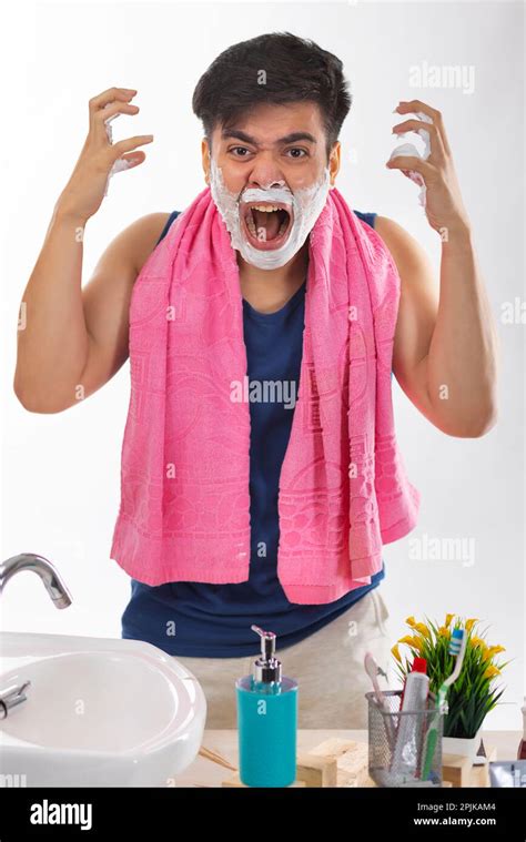 Portrait Of An Angry Young Man Screaming While Shaving Stock Photo Alamy
