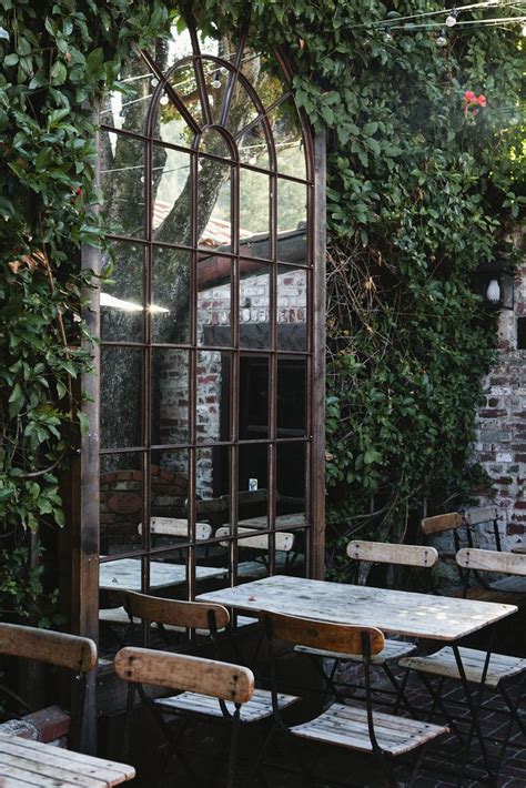 Add An Arched Mirror To Your Outdoor Space To Give Depth