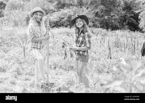 Sisters Together Helping At Farm Girls Planting Plants Rustic