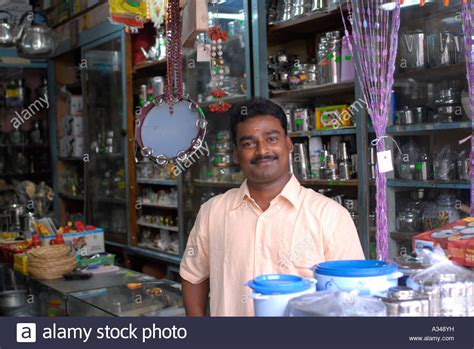 Do take time to establish productive business. Indian small business owner standing in his shop, Little ...