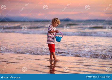 Child Playing On Ocean Beach Kid At Sunset Sea Stock Image Image Of