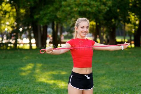 Young Woman Is Training With Rubber Bands Outdoors Healthy Active Lifestyle Concept Stock Image