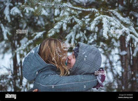 Happy Snow Covered Couple Kissing Under Fir Branches In Winter Forest Concept Healthy Romantic