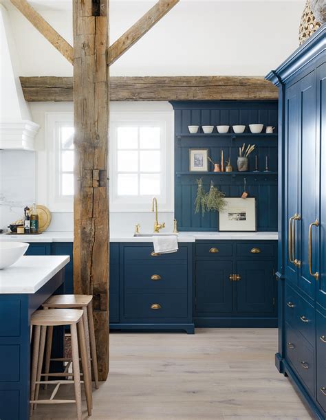 House And Home Moody Cabinetry And Exposed Beams Elevate This Farmhouse