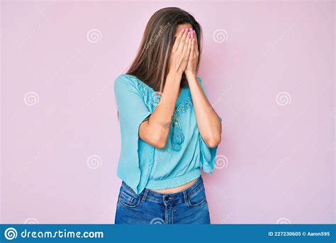 beautiful caucasian woman wearing casual clothes with sad expression covering face with hands