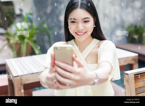 Asian Woman Taking A Selfie With Her Phone In Public Park Focus On Her Face Stock Photo Alamy