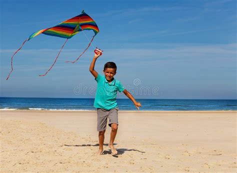 Happy Boy Lay In The Sea Waves Smiling On A Beach Stock Photo Image