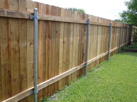 A cross wooden fence with a large format cross between posts. Wood Privacy Fences - Austin TX - Ranchers Fencing & Landscaping