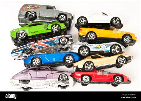 Ten Mini Metal Toy Cars In Bright Colours All Piled Up On Top Of Each