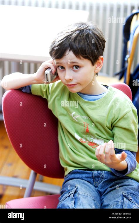 7 Year Old Boy Using A Cell Phone Stock Photo Alamy