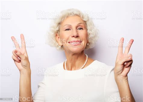 Old Woman Laugh And Showing Peace Or Victory Sign At Camera Emotion And