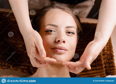 Masseur Is Making Facial Massage In Spa For Model With Perfect Skin Beauty Procedure Stock