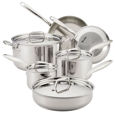Stainless Steel Pots And Pans Are Stacked On Top Of Each Other In This