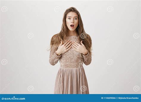 Shocked Attractive Woman Sitting On Cosy Sofa Having A Phone Cal Stock
