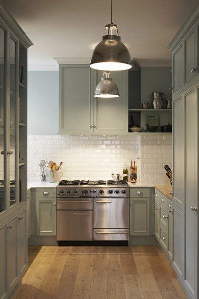 A white subway tile is large. Green-grey cabinets, plank wood floors, white subway tiles ...