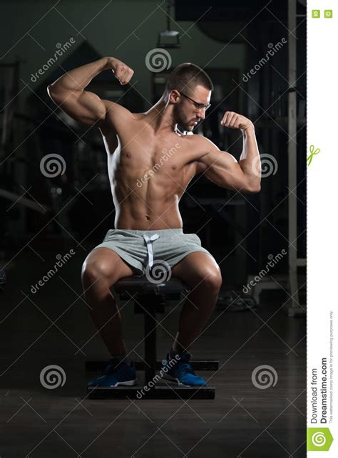 Nerd Man Sitting Strong In Gym Stock Photo Image Of Male Muscles