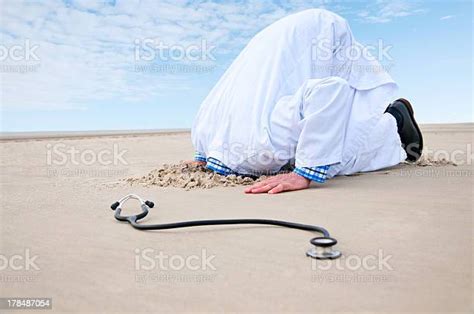 Doctor Hiding Head In Sand Stock Photo Download Image Now Doctor
