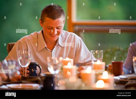 Teenage Boy Sitting At Dinner Table Stock Photo Alamy