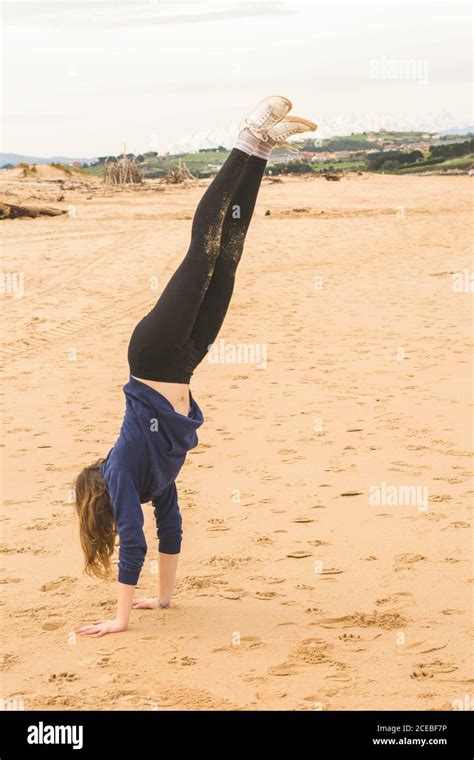 Girl Doing Handstand In The Sand Stock Photo Alamy