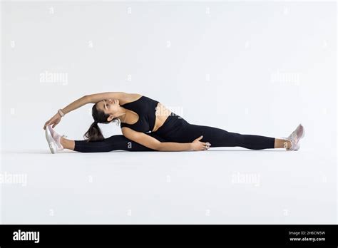 Athletic Girl Doing Hand Exercises Sitting On The Splits Stock Photo Alamy