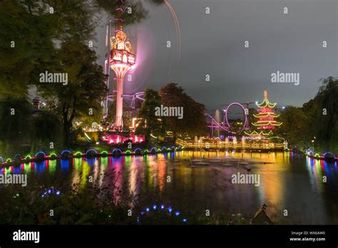 The Illuminated Tivoli Gardens In Copenhagen By Night Stock Photo Alamy