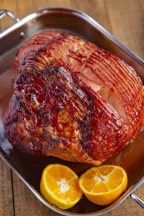 baked ham with brown sugar glaze made with brown sugar orange juice honey and spices is the