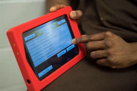 inmate holds a prison tablet showing email prison inmates hold on