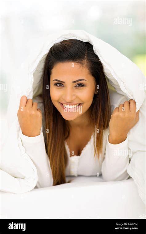 Happy Woman Lying Under Duvet On Bed Stock Photo Alamy