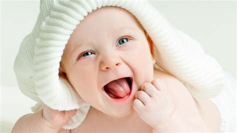Blue Eyes Cute Baby With Opening Mouth Is Having White