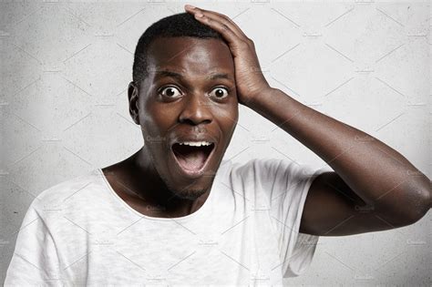 Shocked Or Surprised Young Handsome African Man Shouting In Horror Or