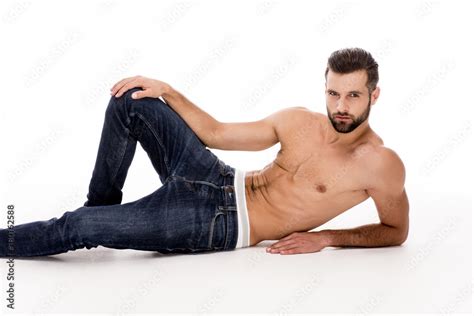 Want To Join Me Handsome Shirtless Young Man In Jeans Looking At Camera While Lying Down