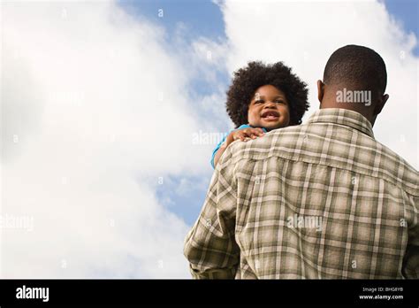 Baby Being Carried By Father Stock Photo Alamy