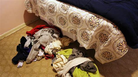 Pile Of Dirty Clothes On Bedroom Floor Starting To Mix With Pile Of