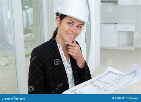 Woman With Hardhat On Posing Holding Blueprint Stock Image Image Of