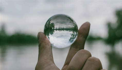 Close Up Photography Of Person Holding Crystal Ball · Free Stock Photo