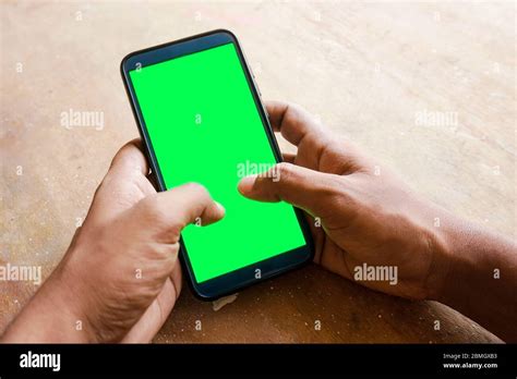 Hand Holding Smart Phone With Green Screen Stock Photo Alamy