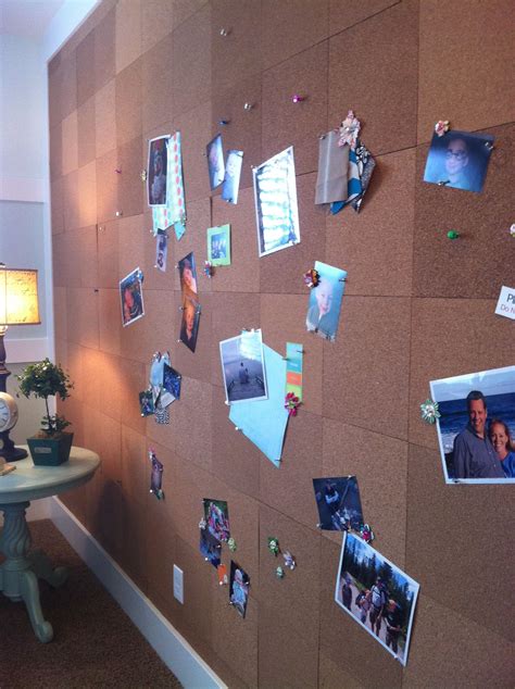 A Cork Board With Pictures And Photos Pinned To It On The Wall Next To