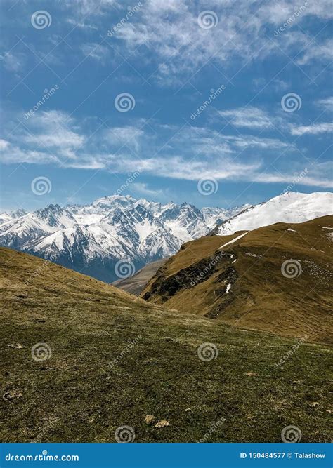 Landscape Of Mountains And Hills Covered With Snow Against The Sky